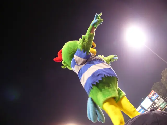 In this image there is a person wearing a mask. He is wearing a costume. Right bottom there is a...