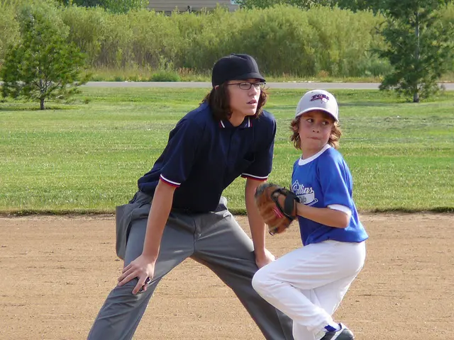 In this image there is a mud road at the bottom. There are two people in the foreground. There is a...