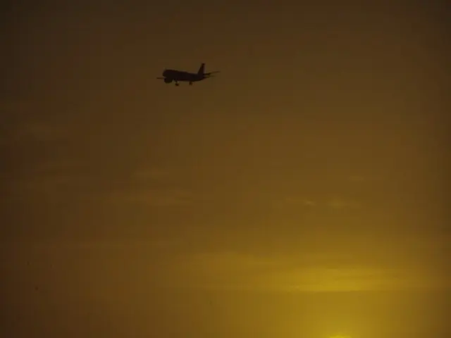 There is an aircraft at the top side of the image, it seems like a moon on the right side.