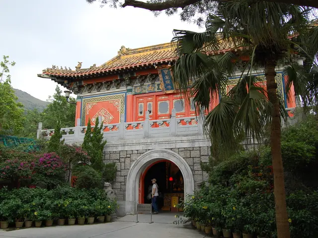 In this picture there is a Po Lin monastery in the center of the image and there are trees on the...