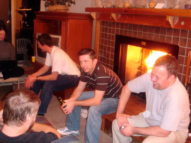 In this picture there are four men who are sitting on the bench. A woman to the left, is sitting on...