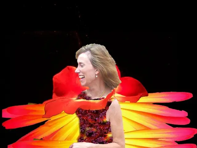 In this image I can see a person wearing different color costume. Background is in black color. It...