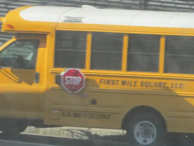 In this image I can see there is a road. On the road there is a van and a stop board attached to...