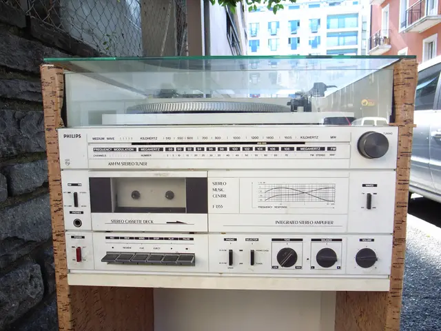 In this picture I can see the radio which is kept on the table, beside that I can see the brick...