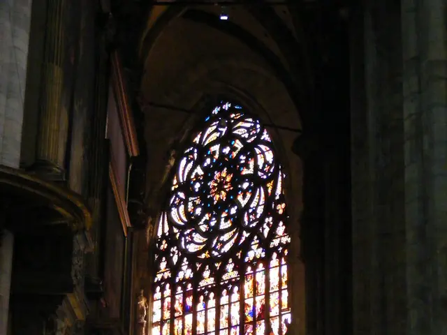 In this image there is a building for that building there is a glass window.