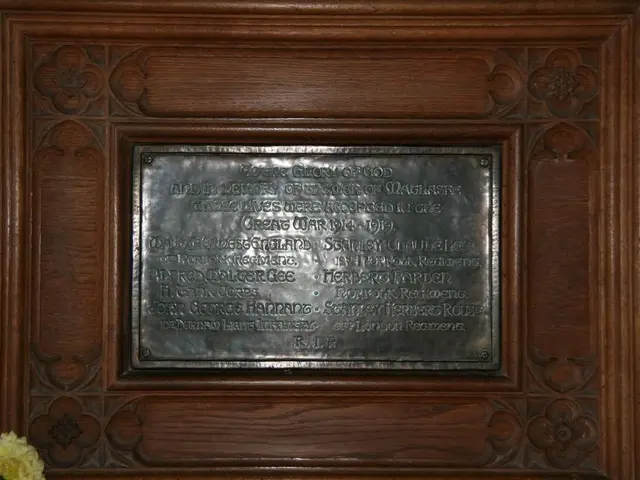 In this picture, we see a commemorative plaque with some text written on it. It is placed on the...