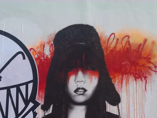 This picture contains a graffiti. At the bottom of the picture, we see the pavement. In the...