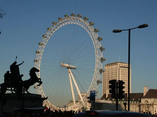In this picture there are buildings and poles on the right side of the image and there is giant and...