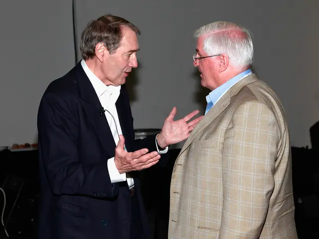 In this image in the center there are two persons who are talking with each other, in the...