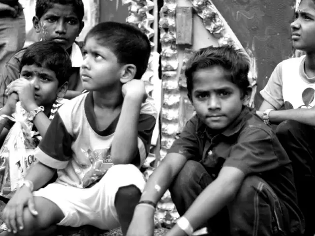 In this picture there are children in the center of the image, it seems to be a door in the...