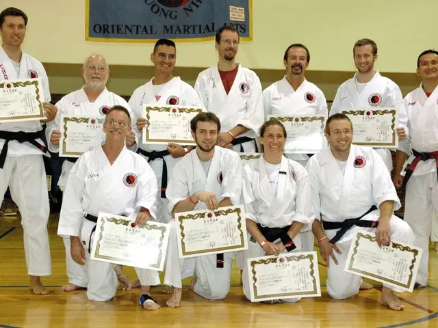 In this image we can see persons standing and some are sitting on the floor. All the persons are...