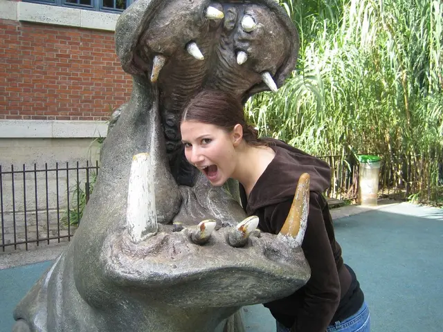 This image is clicked outside. There is a statue in the middle. There is a woman in the middle. She...