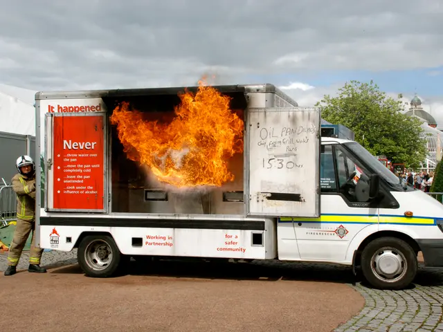 In this picture I see a van in front which is on fire and I see a man behind this man and I see...