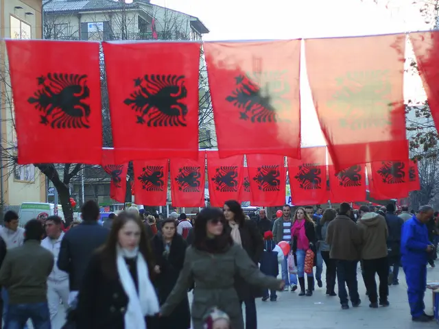 In this image I can see group of people walking. In front the person is wearing grey color jacket,...