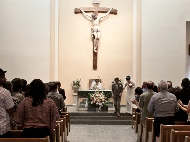 In this image we can see there are few people attending the ceremony of a newly wed. In the...