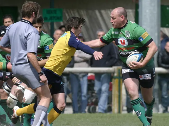 In this picture we can see a group of people running for ball hold by this person on ground and in...