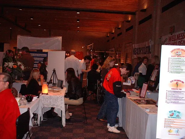 At the top we can see ceiling and lights. Here we can see few persons standing and busy with their...