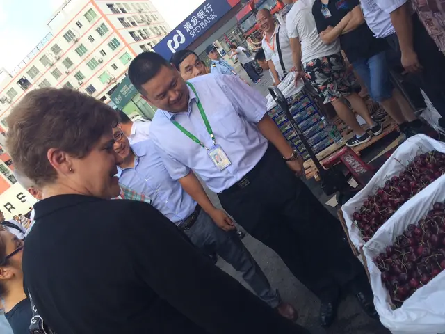 This image is clicked on the road. There are people standing on the road. In the bottom right there...