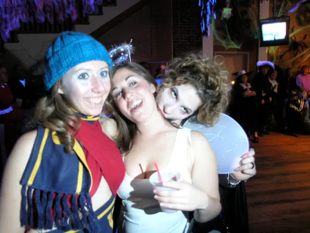 In the picture it looks like some party and there are three women in the foreground, behind them...