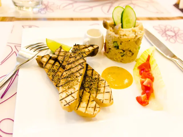 In the image there are some cooked food items served on a plate and there is a fork and a knife...