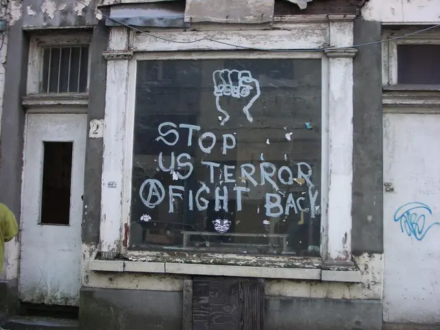 This looks like a building with the windows. I can see a glass door with the letters written on it.