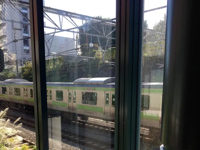 At the bottom of this image, there is a child sitting. Beside this child, there is a glass window....