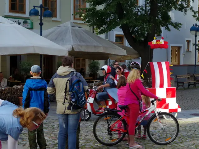 This is an outside view. Here I can see few people are riding their bicycles and few people are...