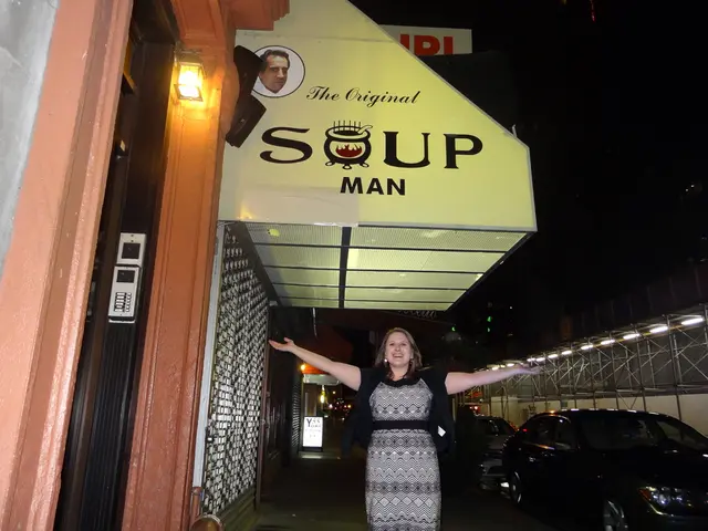 In this image there is a woman standing on the walkway. She is spreading her hands out and she is...