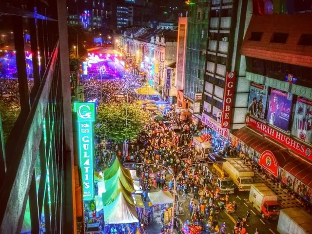 In the image it looks like some carnival, there is a huge crowd on the road and around them there...