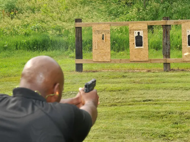In the image there is a bald headed man in green shirt shooting gun in the front on the wooden...