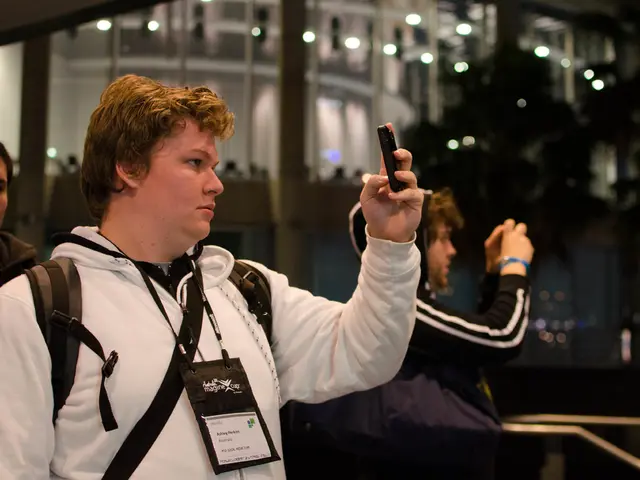 In this picture we can see people standing and taking pictures of something in their mobiles.