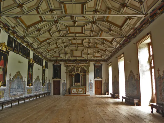 In this image we can see the interior view of a hall where there are frames attached to the walls,...