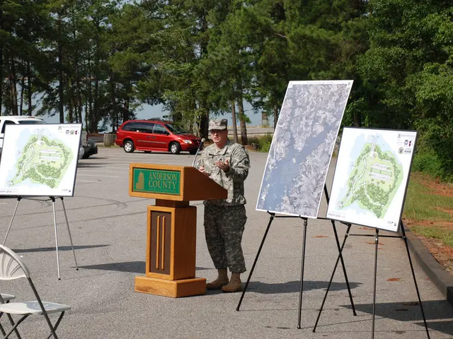 This person is standing. In-front of this person there is a podium with mic. These are posters....