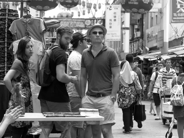 In this picture there are people and stalls on the right and left side of the image, it seems to be...