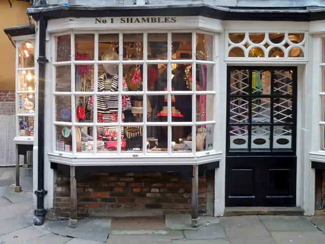 In this picture I can see a shop, there are lights, clothes and some other objects in the shop, and...