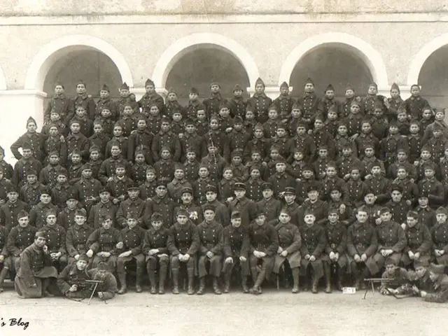 Here in this picture we can see a number of people standing and sitting over a place and we can...