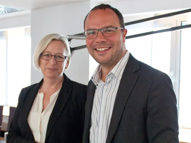 In this picture we can see a man and a woman shaking hands and smiling. We can see this man is...