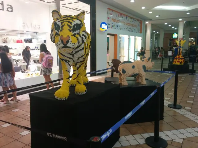 There are statues of animals on black color boxes. Around the boxes there are poles with elastic...