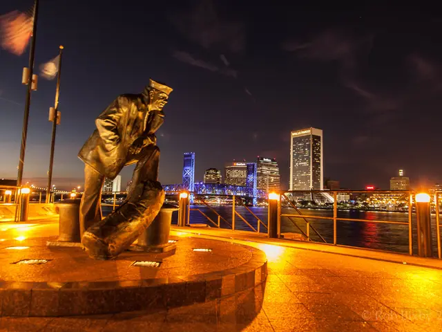In this picture there is a statue of a person and there are flags and there are lights on the...