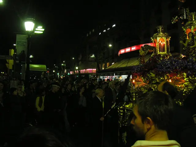 In the image we can see there are lot of people standing and there are lot of buildings.