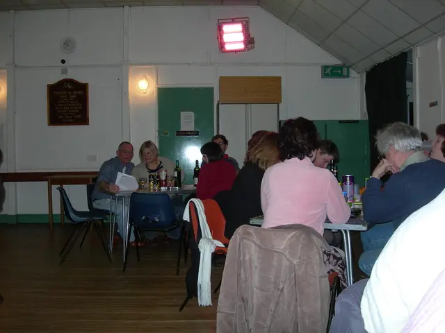 This is a picture clicked inside the room. In this I can see few people are sitting on the chairs...