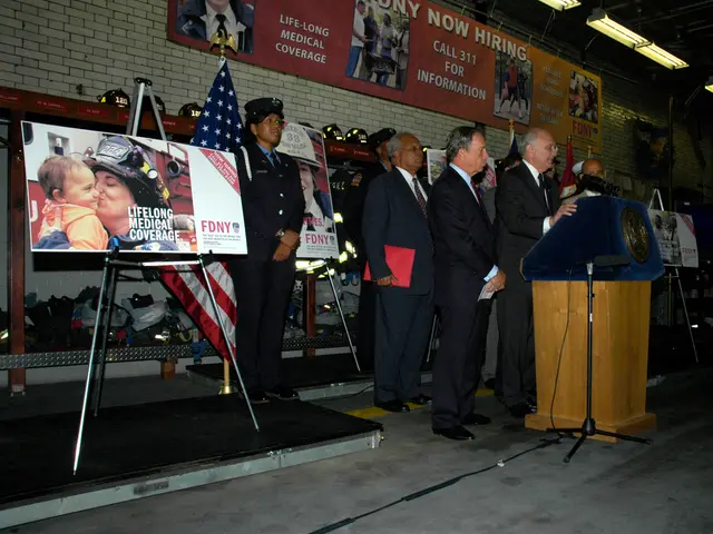 In this image there are boards on the stands, flags, mikes, group of people standing near the...