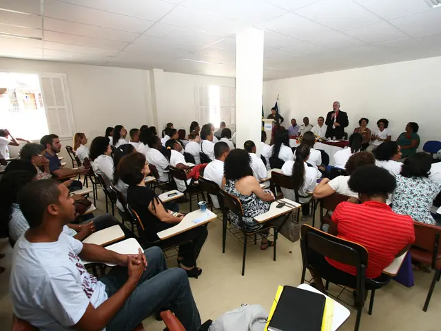 This picture describes about group of people in the room all are seated on the chairs except two...