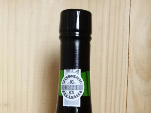 In this image there is a beer bottle with the labels on the wooden path.