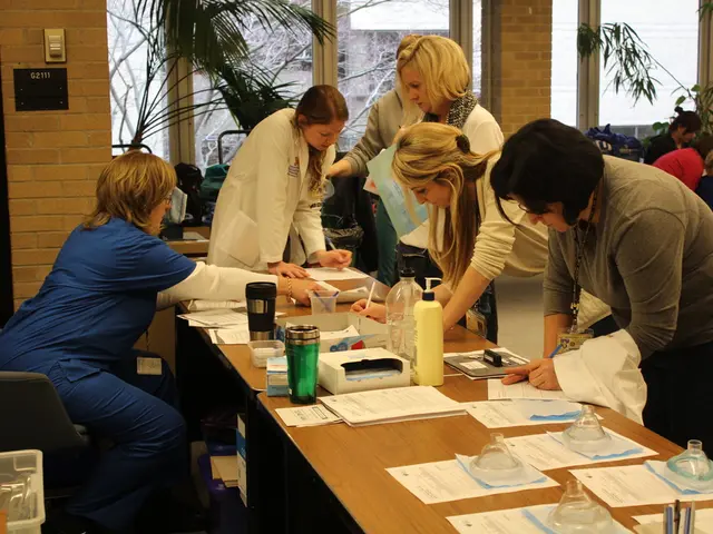 It is a closed room in which people are standing in front of desk and at the left corner one woman...