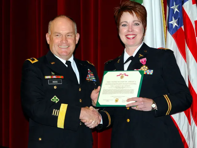 These two people are giving shake-hand and smiling. This woman is holding a certificate. Background...