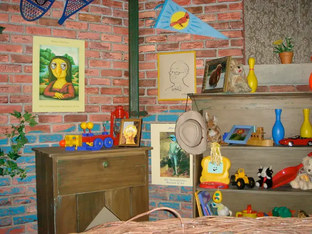 In this image this is a picture of a room where there are frames attached to the wall, pole , toy...