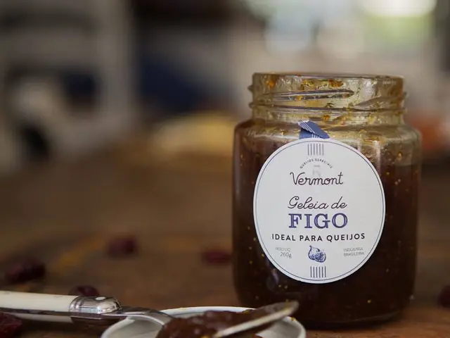 In the center of the image we can see jar, spoon placed on the table.