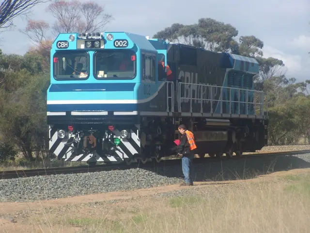 In this picture we seeing the train is not in motion it is standing and man is standing near the...