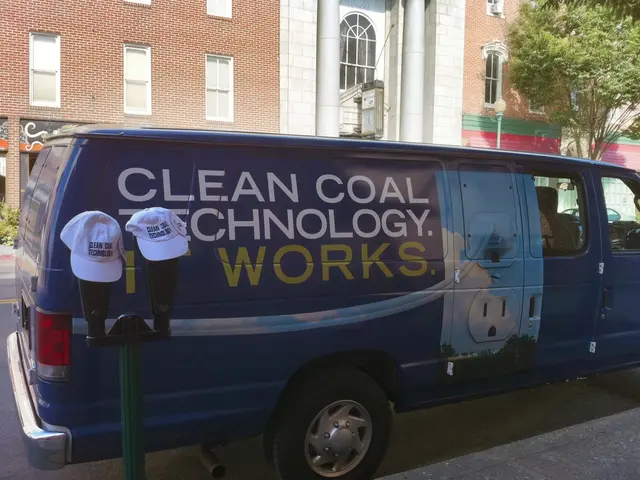 Here I can see a blue color van on the road. On the left side there is a pole on which I can see...